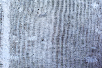 The texture of torn white fabric with a large cage or burlap, curtain, background