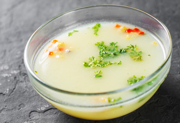 chicken cream soup in the glass bowl on Dark grey black slate background