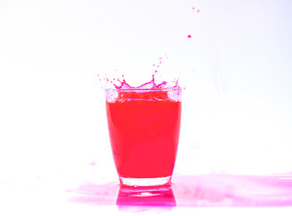 Red Juice splash in glass isolated on white background