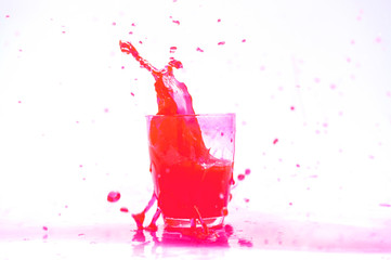 Red Juice splash in glass isolated on white background