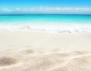 Tropical white sandy beach and blue sea blurred background.