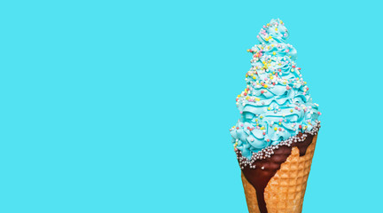 Ice cream cone close-up. Curled ice cream on a wafer with chocolate topping. Blue color with a...