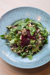 Vegeterian salad on table with red wine