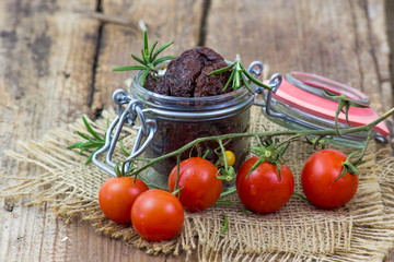 fresh and dried tomatoes on wooden background