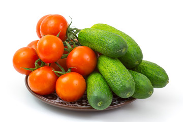 fresh vegetables on a plate on white background