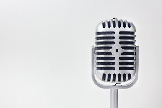 The vintage microphone close up image on white background..