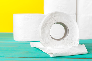 Toilet paper stacks  on bright yellow background