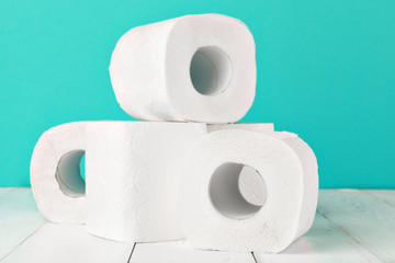 Toilet paper rolls on turquoise bright background