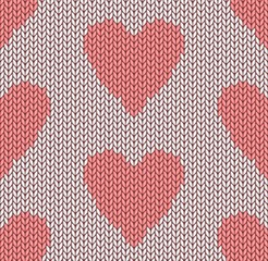 The Seamless pink knitted background with hearts.