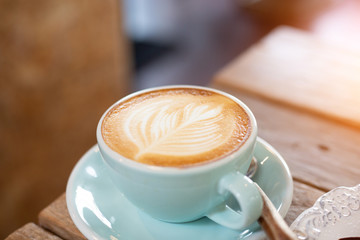 Latte arts coffe hot coffee on wooden table.barista art concept.