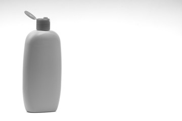 Baby oil or shampoo bottle isolated on white background. Copy Space and Black and White