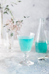 Colorful refreshing summer drink with basil seeds on light background.