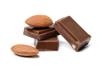 A composition of small chocolate bars and almond nuts. White isolated background. Close-up. Side view.