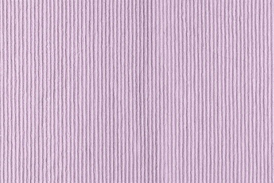 Sofa upholstery close-up. Texture of rough dense ribbed fabric. Lilac blank background for layouts.