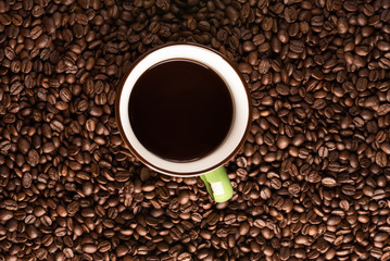 coffee mug with coffee on coffee bean texture