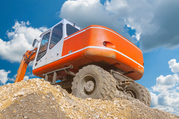Excavator on a Heap of Gravel
