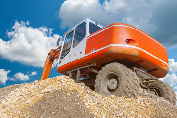 Excavator on a Heap of Gravel