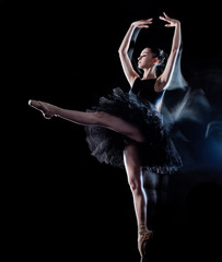 one caucasian young woman ballerina dancer dancing isolated on black background with  light painting motion blur speed effect