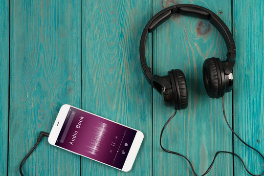 phablet and headphones on the wooden desk