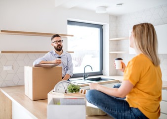Fototapeta premium A young couple drinking coffee when moving in new home.