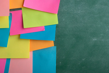 Colorful sticky notes on the blank blackboard