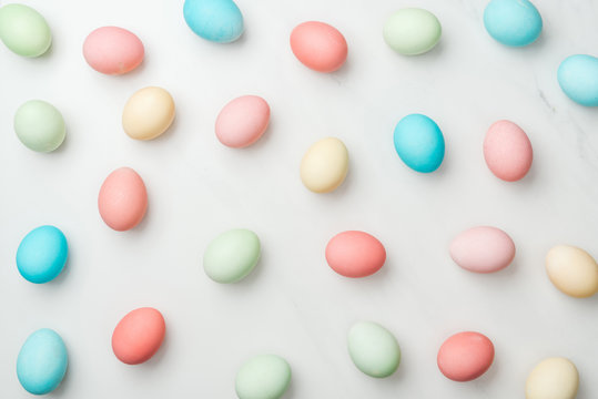 background with colorful pastel easter eggs on white