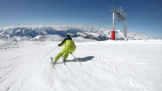 Female skier go down on ski route