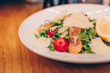 Waiter serving Salad rucola asparagus salad Caesar at restaurant, close up view. Eating and leisure concept. Toned image. Design healthy lifestyle Organic Gourmet and luxury concept service