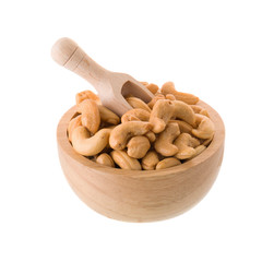 Closeup of cashew nuts in a wooden bowl isolated on white background