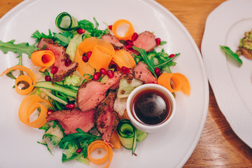 Waiter serving Grilled Skewers chicken fillet meat with baked vegetable pepper apperitive garnish at restaurant, close up view. Selective focus. Design Gourmet and luxury concept service