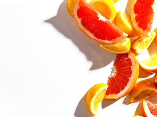 Slices of juicy grapefruit and lemon on white background. Top view.