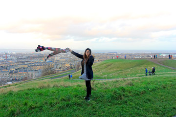 visitors playing on Carlton hill, Edinburgh, UK.