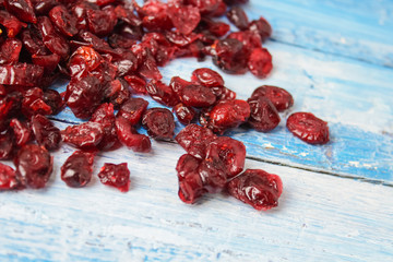 dried cranberries and cherries on wooden background