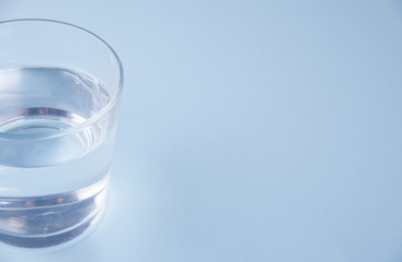 Glass with water on a blue background