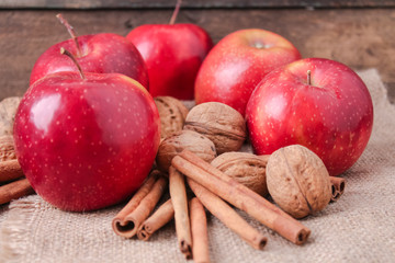 cinnamon sticks and apples on wooden background