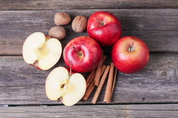 cinnamon sticks and apples on wooden background
