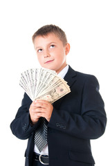 Young enterprising boy schoolboy in a business suit holding money in his hands. How to earn the first million dollars