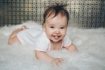 portrait of a newborn baby with his tongue sticking out