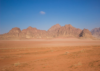 Fototapeta na wymiar Wadi Rum Muddle East desert scenery landscape in Jordan country with sand valley foreground and panorama bare mountain ridge background, travel and touristic concept photography pattern 