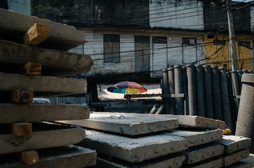 colorful umbrella amidst concrete construction material in Bangkok, Thailand