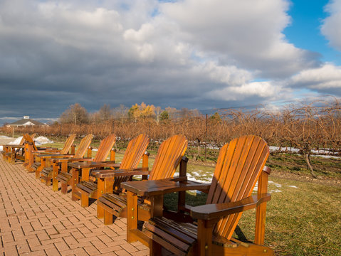 empty wooden chairs at vineyard