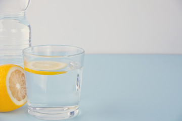 water with lemon on the blue table