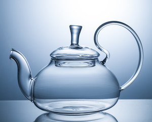 Empty glass teapot on a gray background
