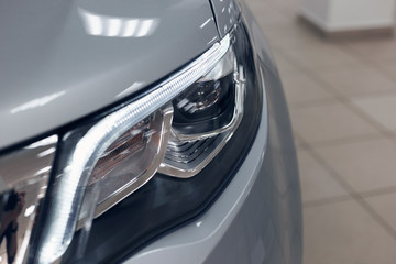 Closeup headlights of a modern car. Detail on the front light of a car. Modern and expensive car concept