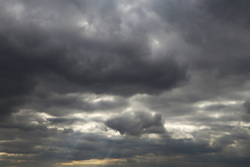 Storm sky covered with dark cumulus clouds before the rain. Spring cloudy sky, overcast day, beautiful dramatic background for stormy weather