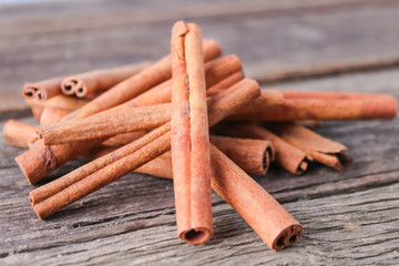 cinnamon sticks on wooden background
