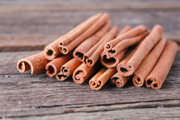 cinnamon sticks on wooden background