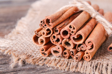 cinnamon sticks on wooden background