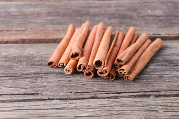 cinnamon sticks on wooden background