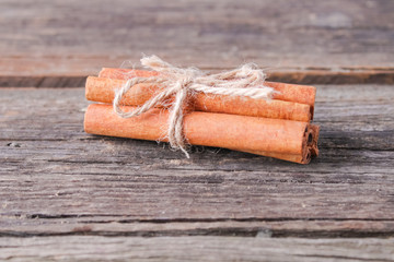 cinnamon sticks on wooden background